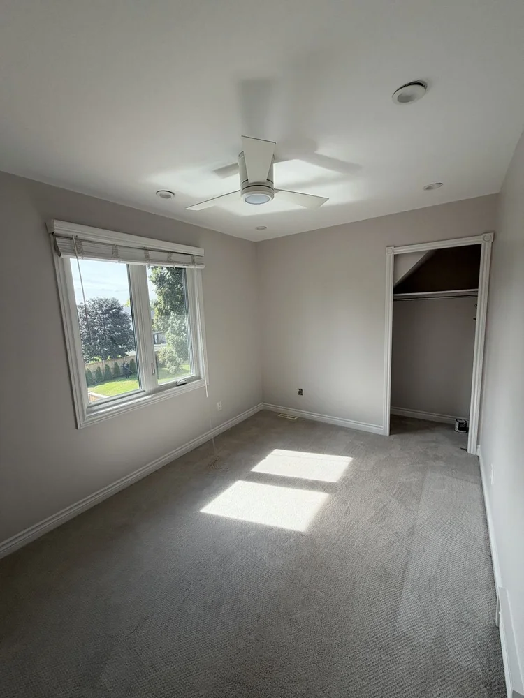 Bedroom repainted in Fall Chill with white trim in Dorchester, Ontario