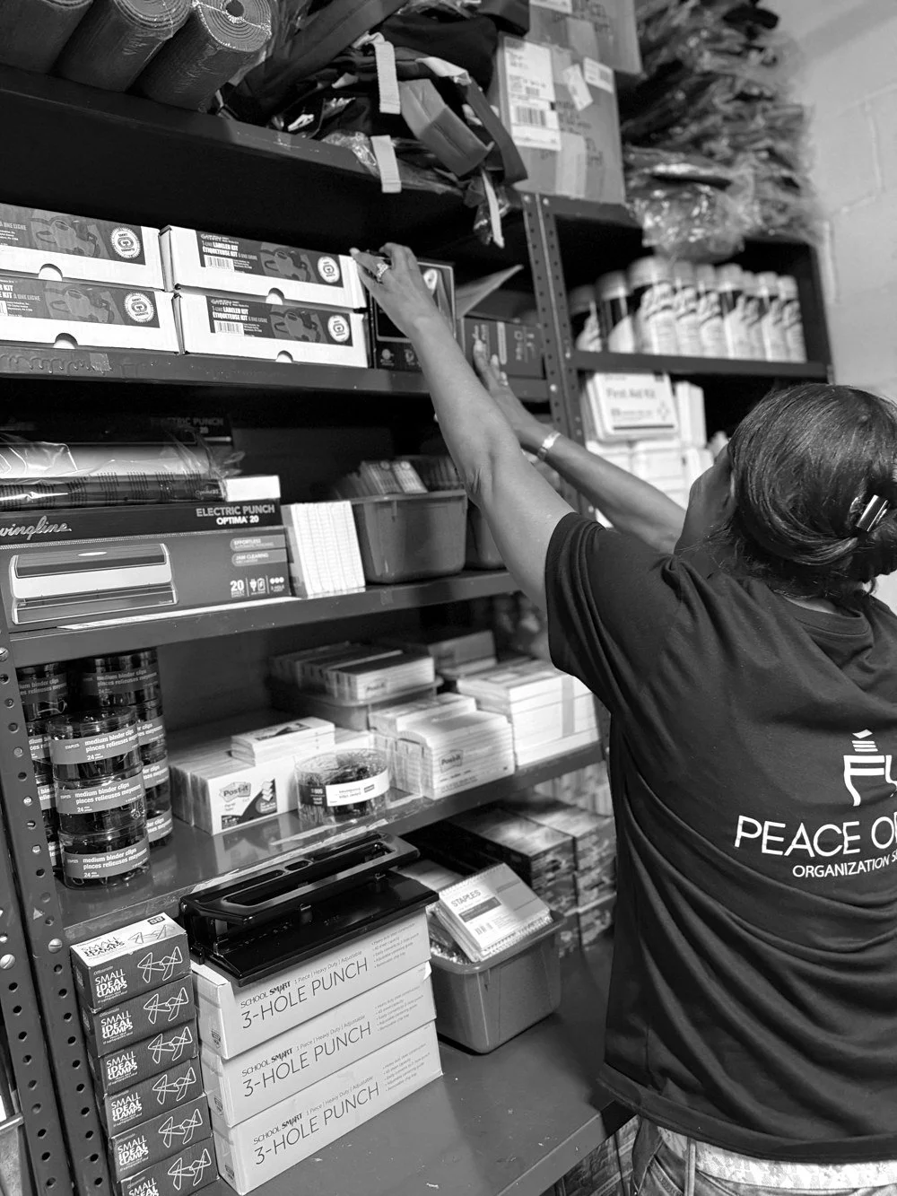 Peace of Find team member organizing shelves