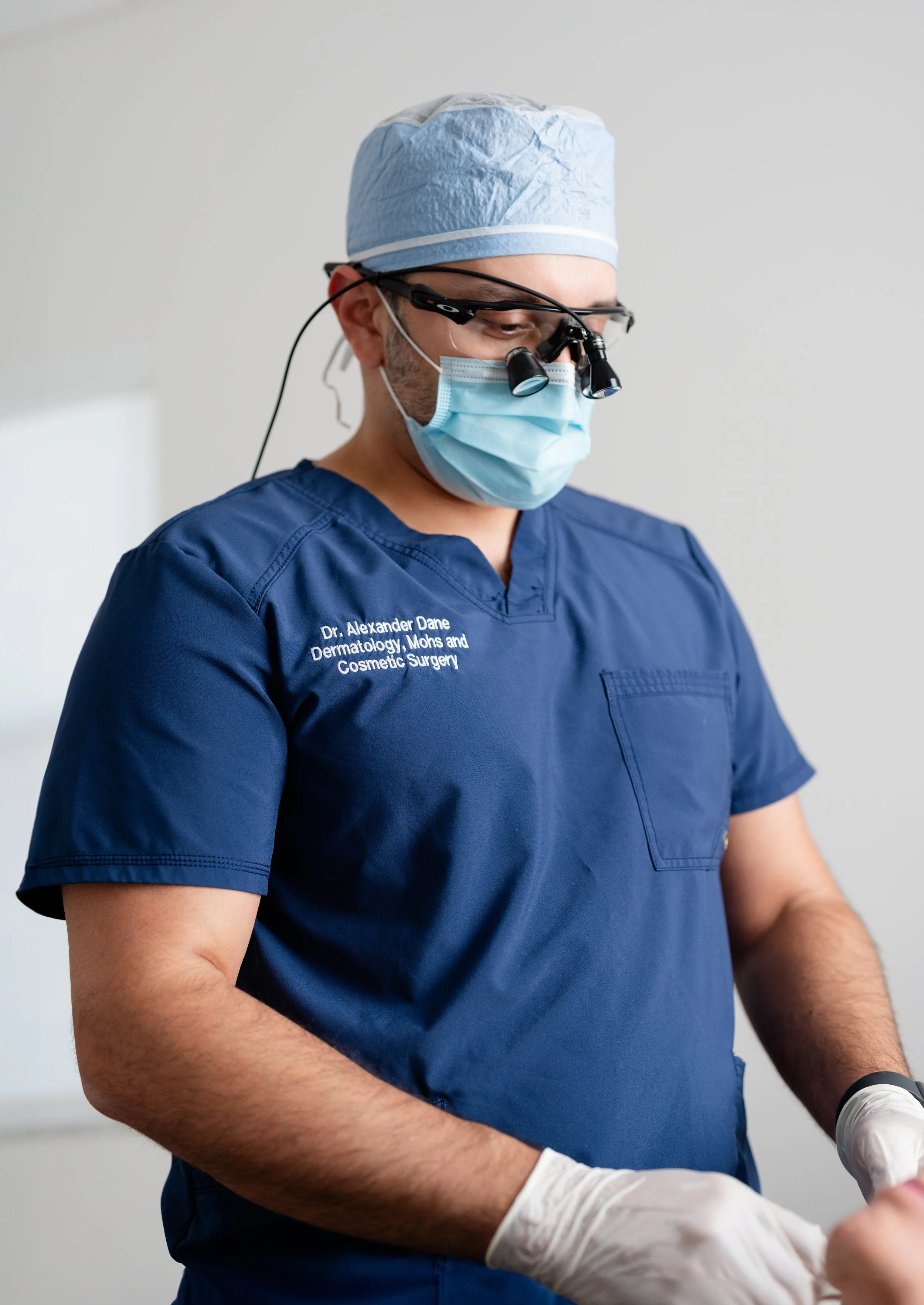 Dr. Alexander Dane in surgical scrubs, a detailed and focused shot of his professional profile