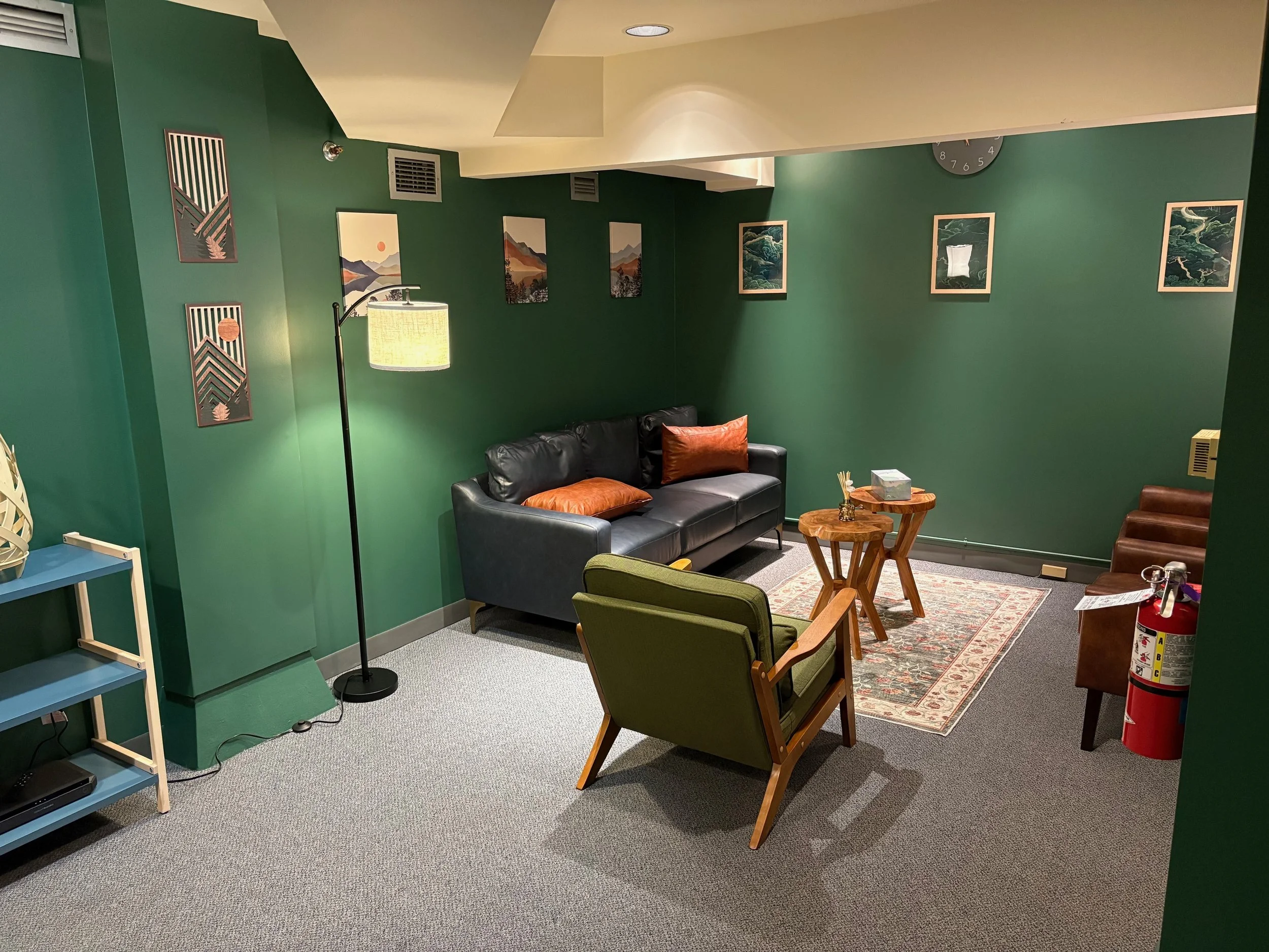 HTNW Portland therapy room — full seating arrangement with rug and framed artwork