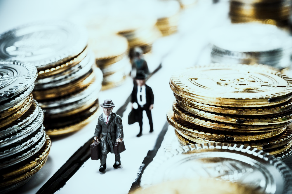 birdseye view of a handshake over a laptop and professional looking documents