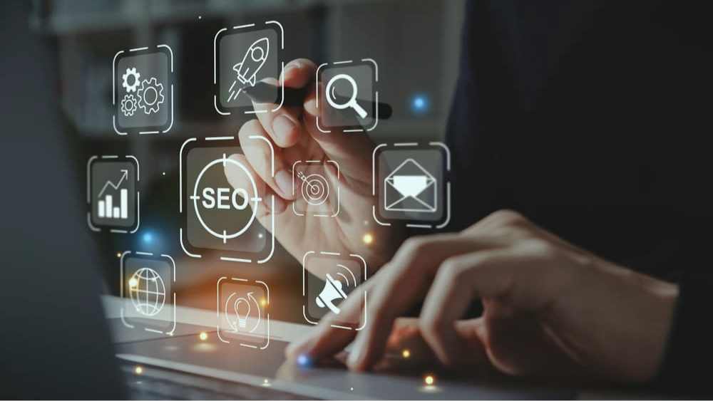 birdseye view of a handshake over a laptop and professional looking documents