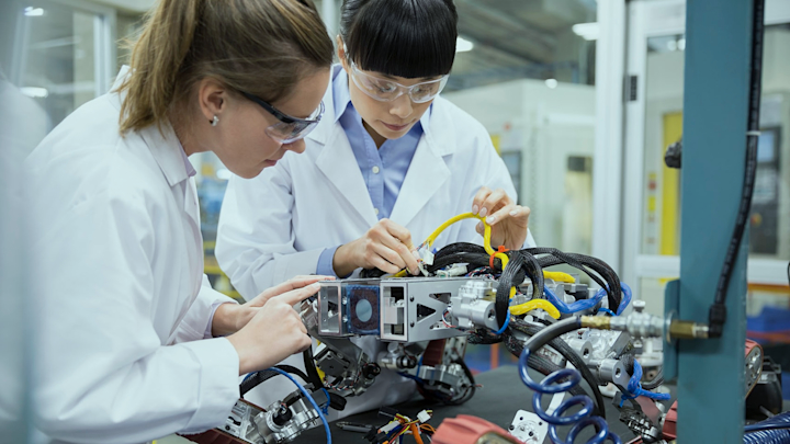 birdseye view of a handshake over a laptop and professional looking documents