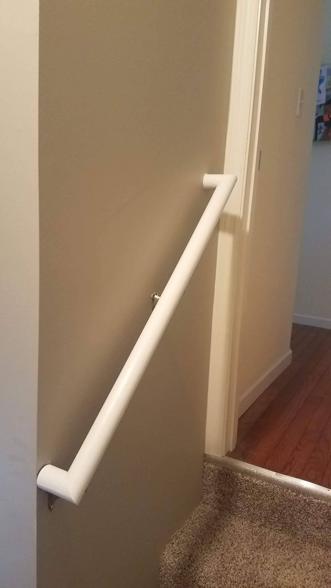 White handrail installed along a staircase for senior safety