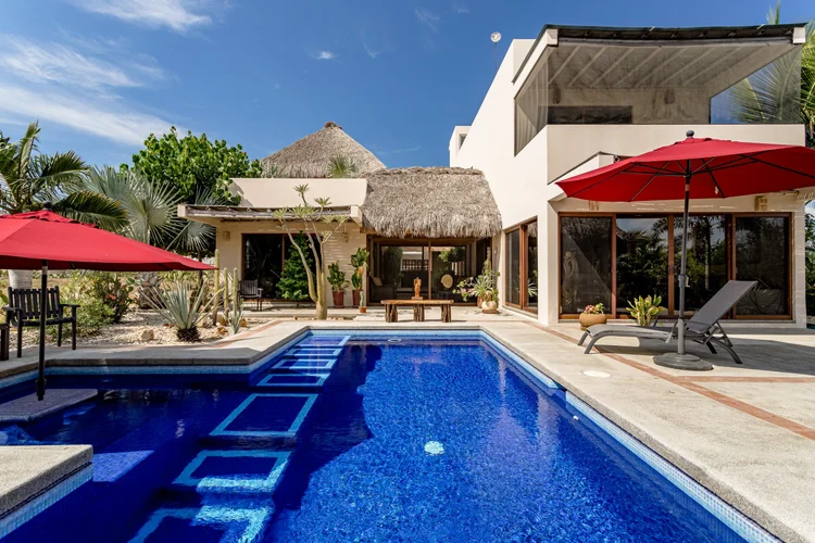 Private pool in front of the two-storey Casa Sol villa with a palapa roof section, Lot 41, Vivo Resorts