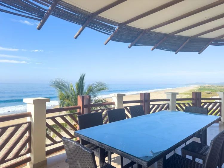 Balcony table looking out over the beach and breaking waves at Unit 833, Building H, Vivo Resorts