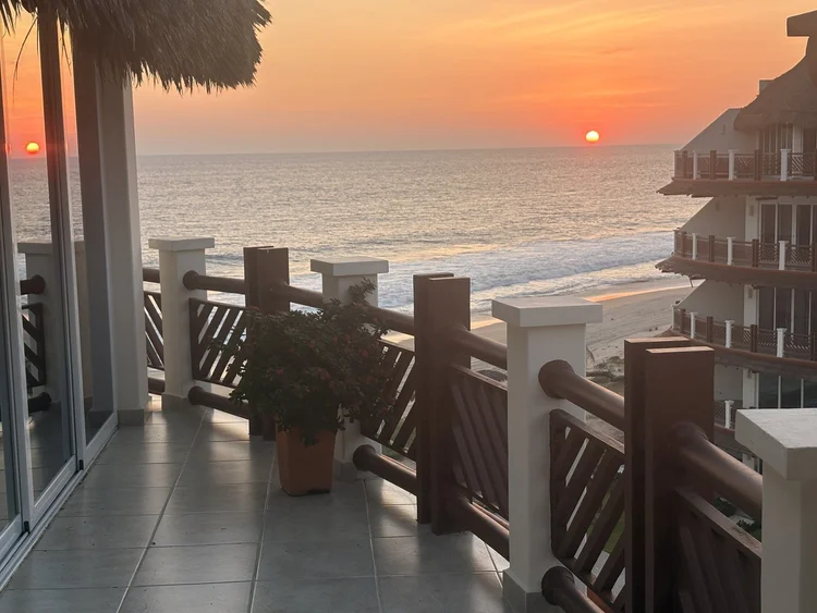 Terrace view of the beach and ocean at sunset from Unit 851, Building H, Vivo Resorts