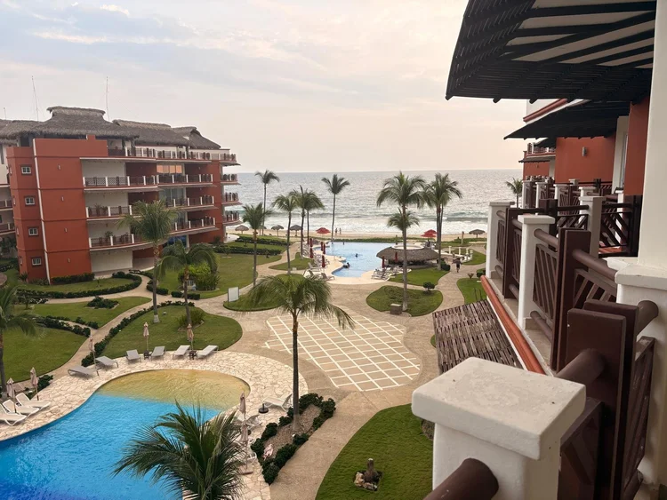 Balcony view over the pools and gardens toward the ocean from Unit 242, Building B, Vivo Resorts