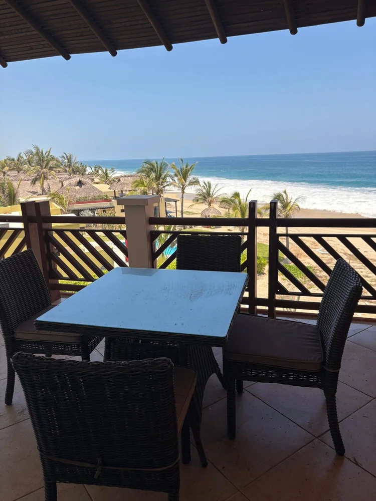 Terrace dining table with palm and ocean views at the Unit 642 and 652 penthouse, Building F, Vivo Resorts
