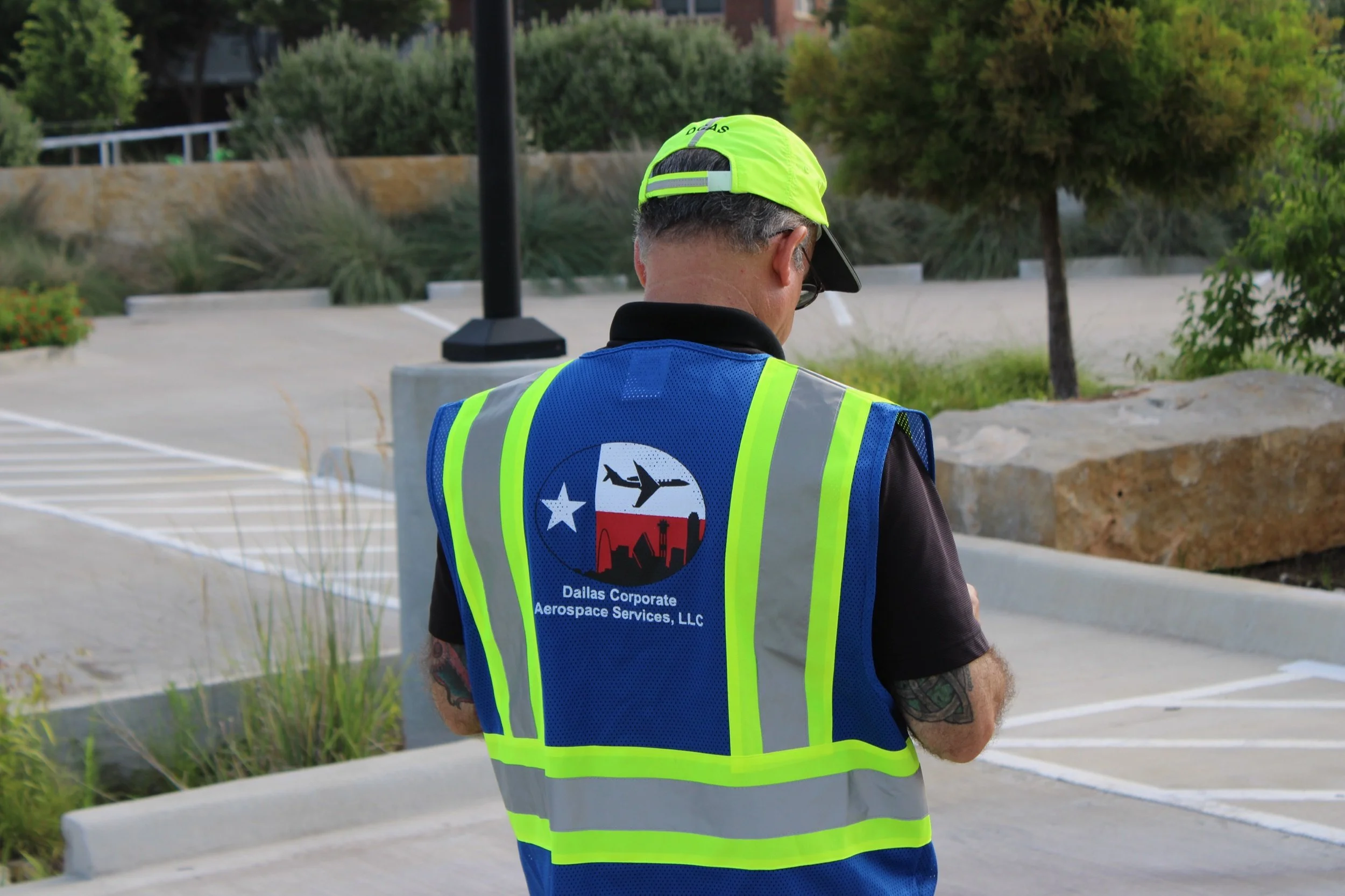 Dallas Corporate Aerospace Services branded safety vest, close-up