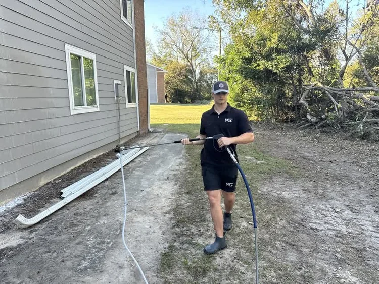 V&G crew member walking in with a hose
