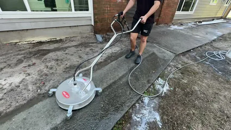 Rotary surface cleaner on a concrete driveway