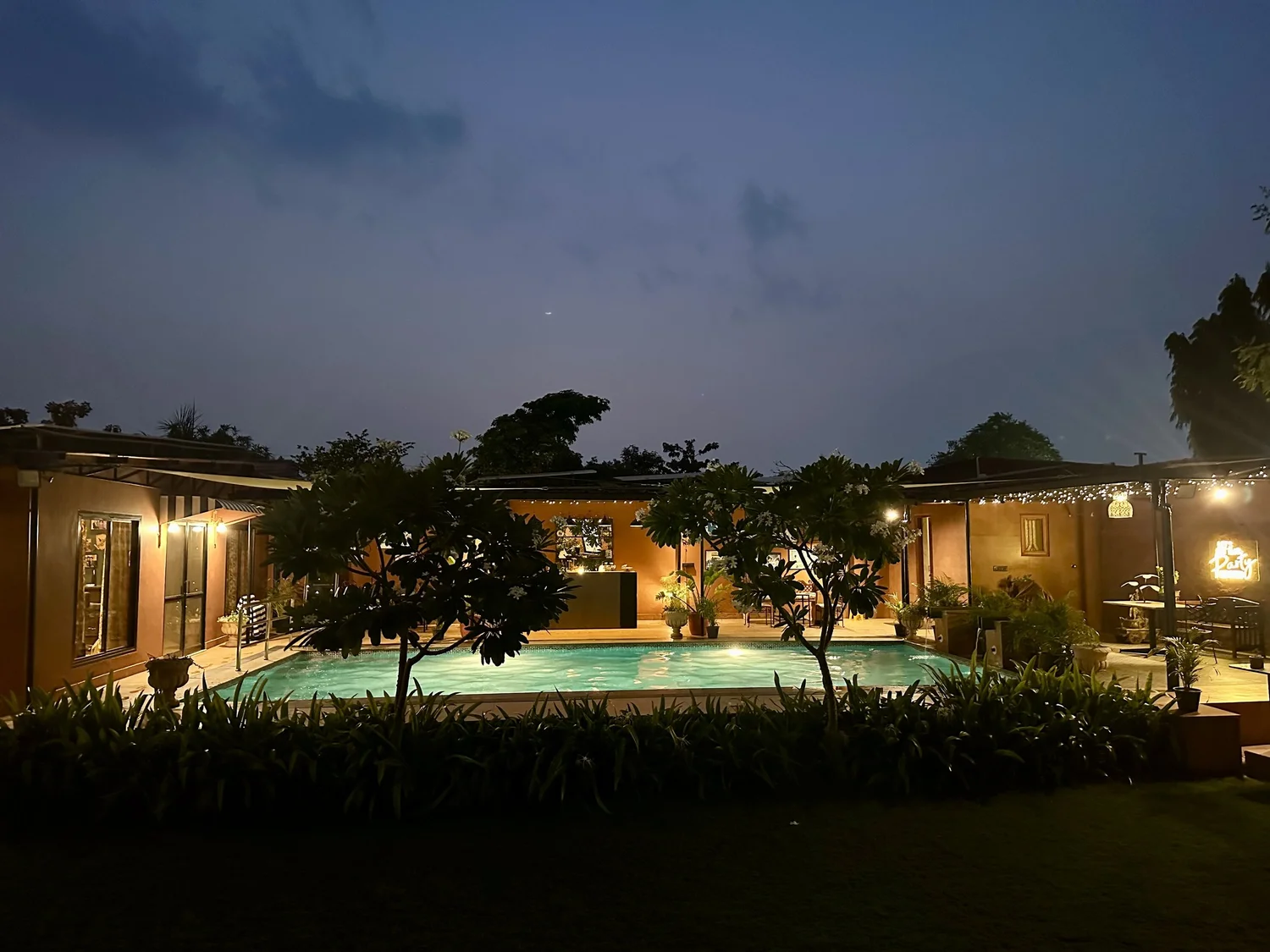 The villa and pool lit up at night