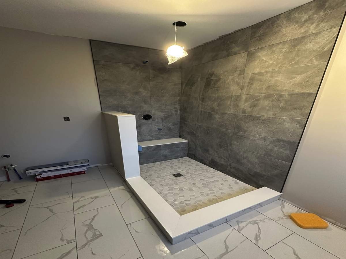 Completed bathroom renovation with walk-in shower and freestanding tub in Toronto