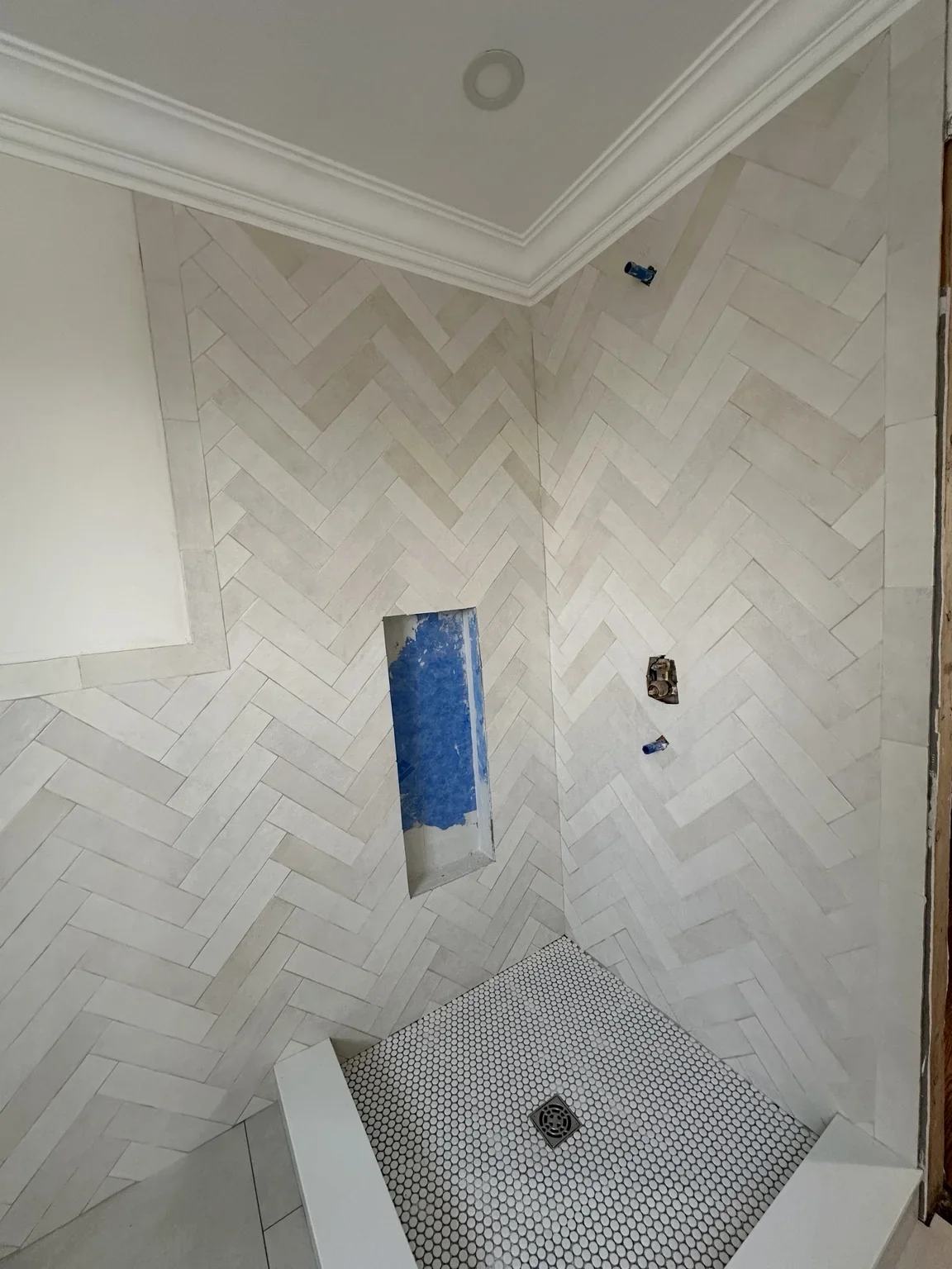 Custom shower herringbone tile installation in Oakville