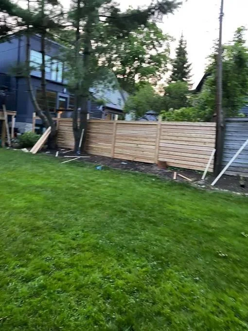 Backyard fence construction with horizontal panels