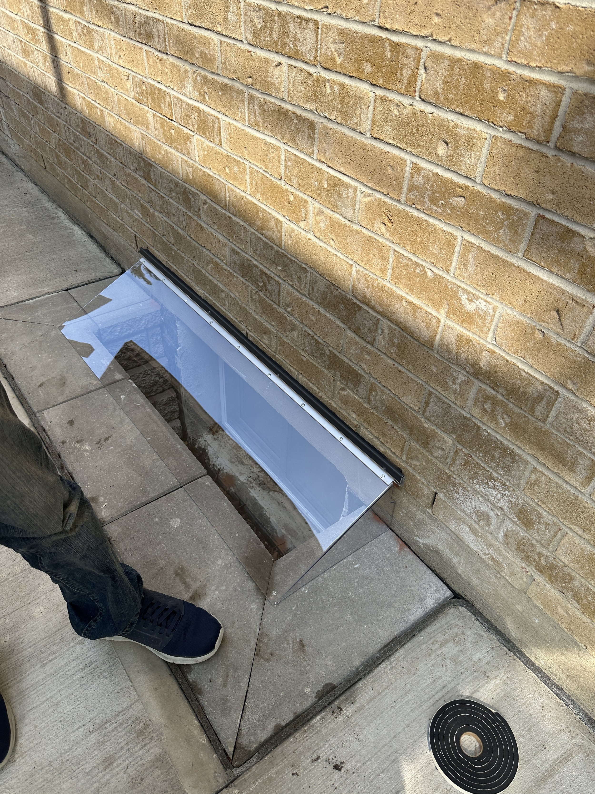 Clear basement window well cover installed on Toronto home