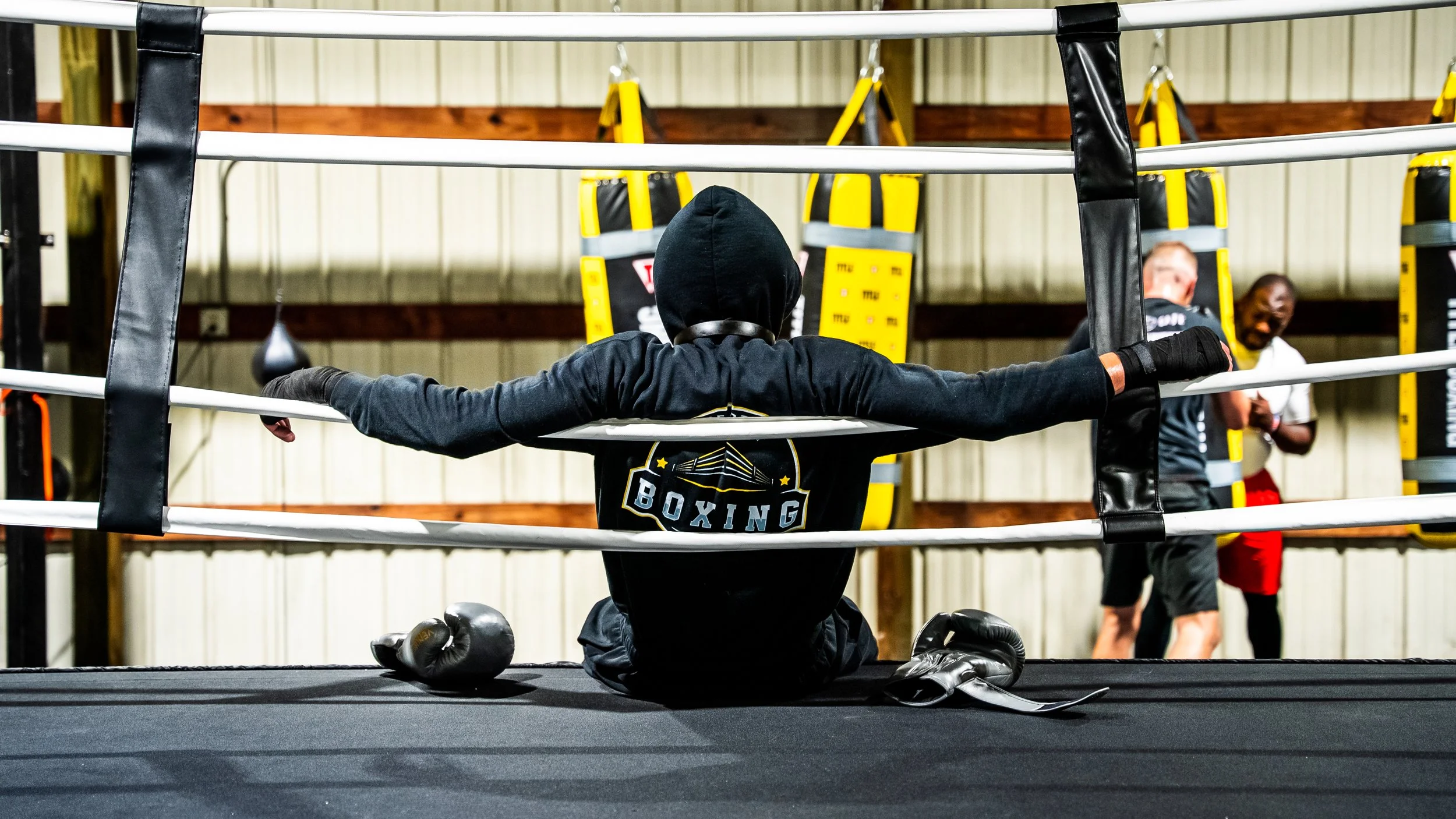 Boxer resting against the ropes at Art of Boxing USA