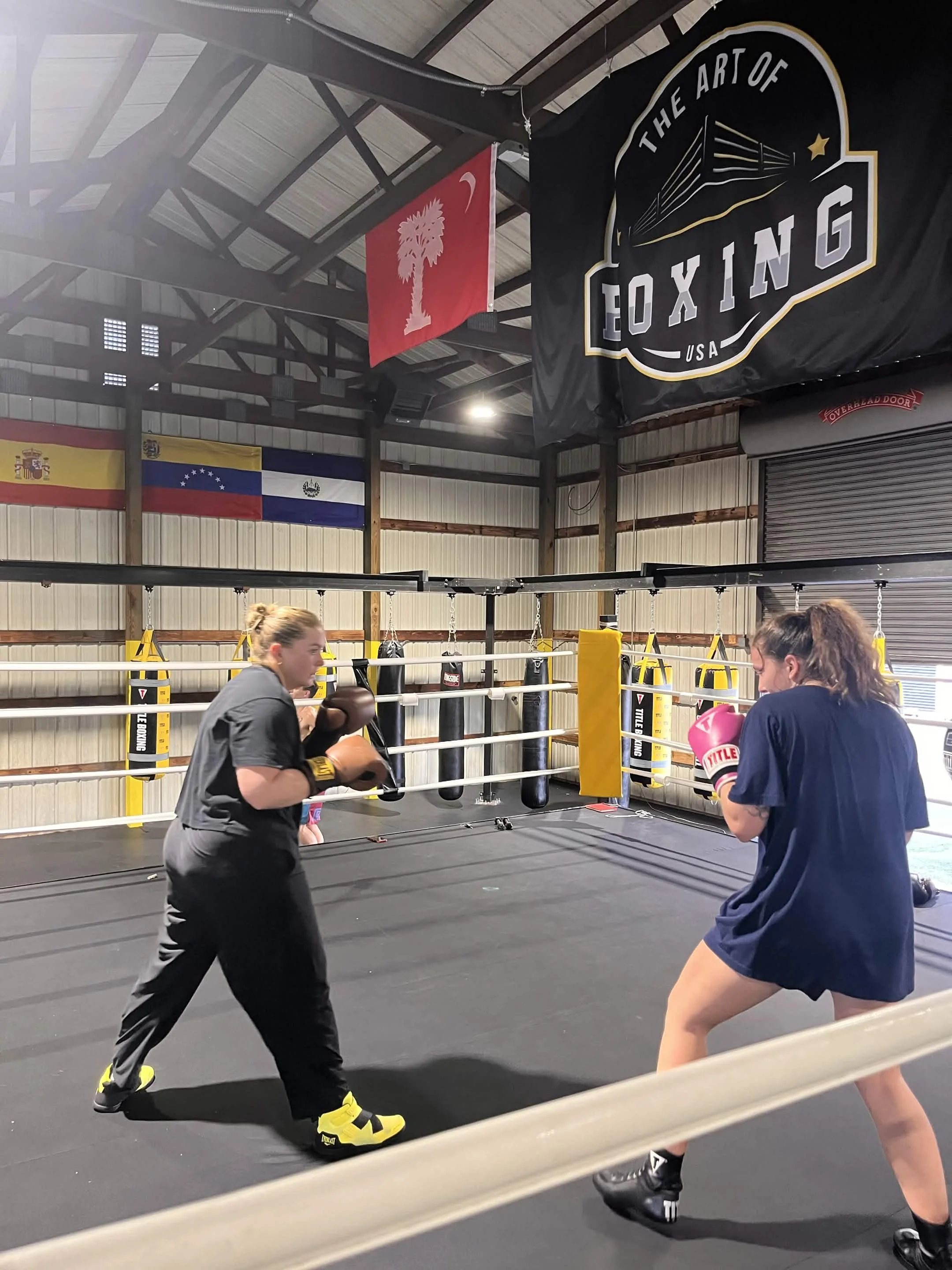 Coach working pads one-on-one with a student
