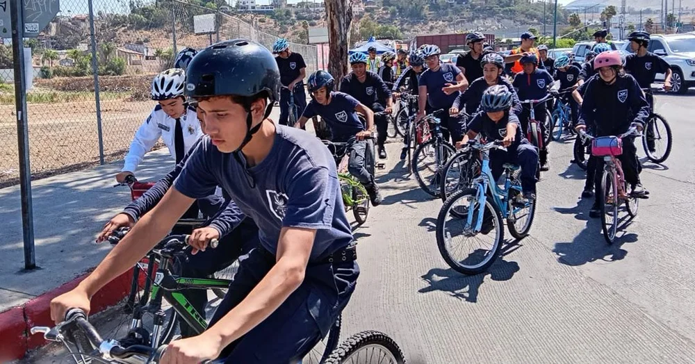 Students ride together on a community bike ride in Tijuana
