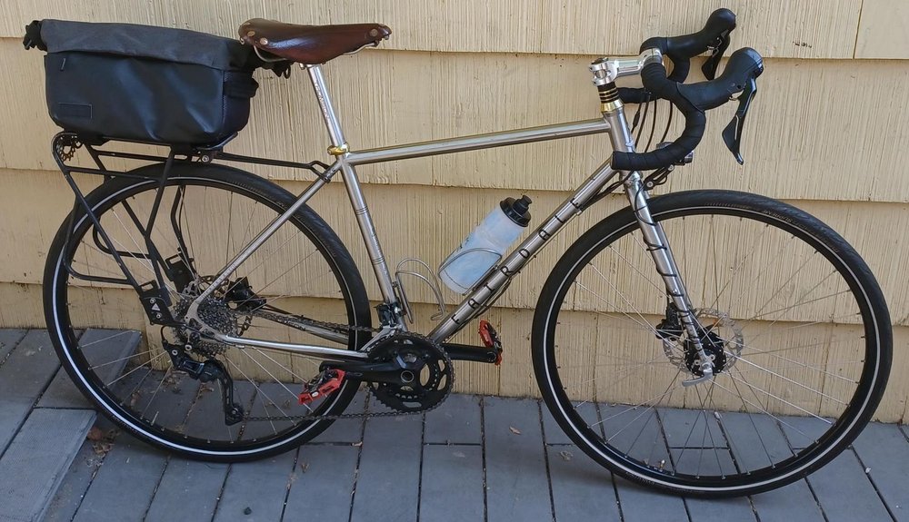 A silver Fairdale touring bike with a rear rack and bag