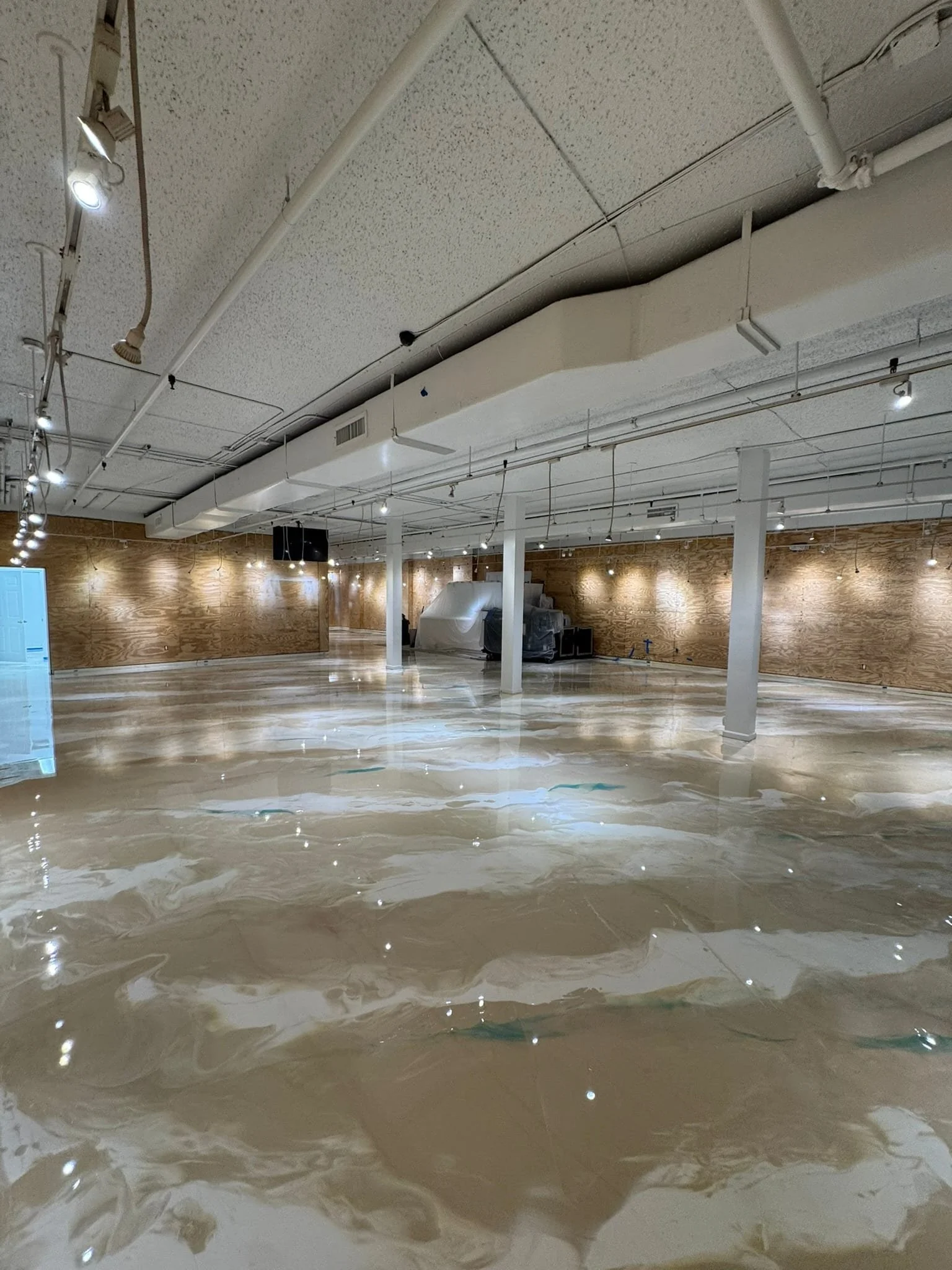 Reflective cream floor with teal and white swirls