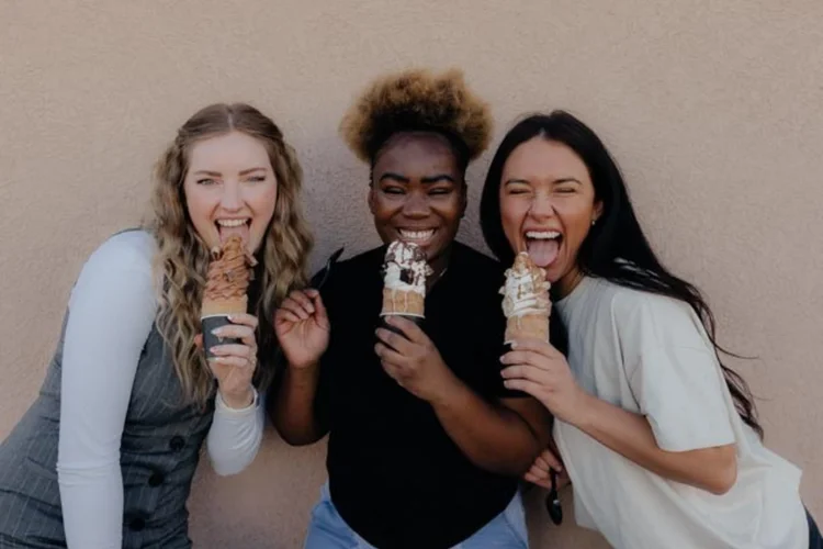 Three friends laughing and eating Crispy Cones