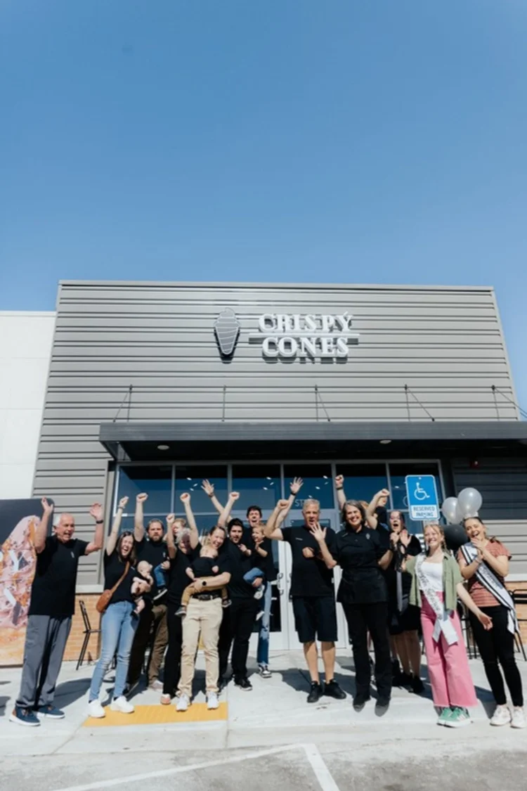 A Crispy Cones team celebrating opening day outside their store