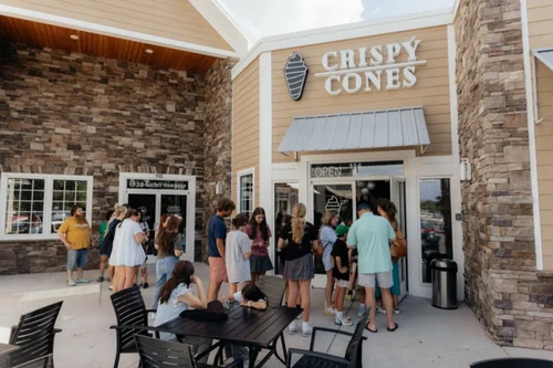 Guests lined up outside a Crispy Cones grand opening