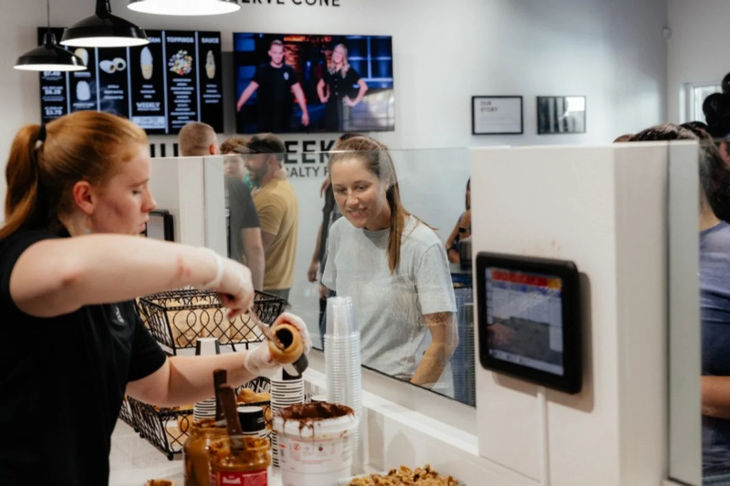 Guests ordering at a Crispy Cones counter