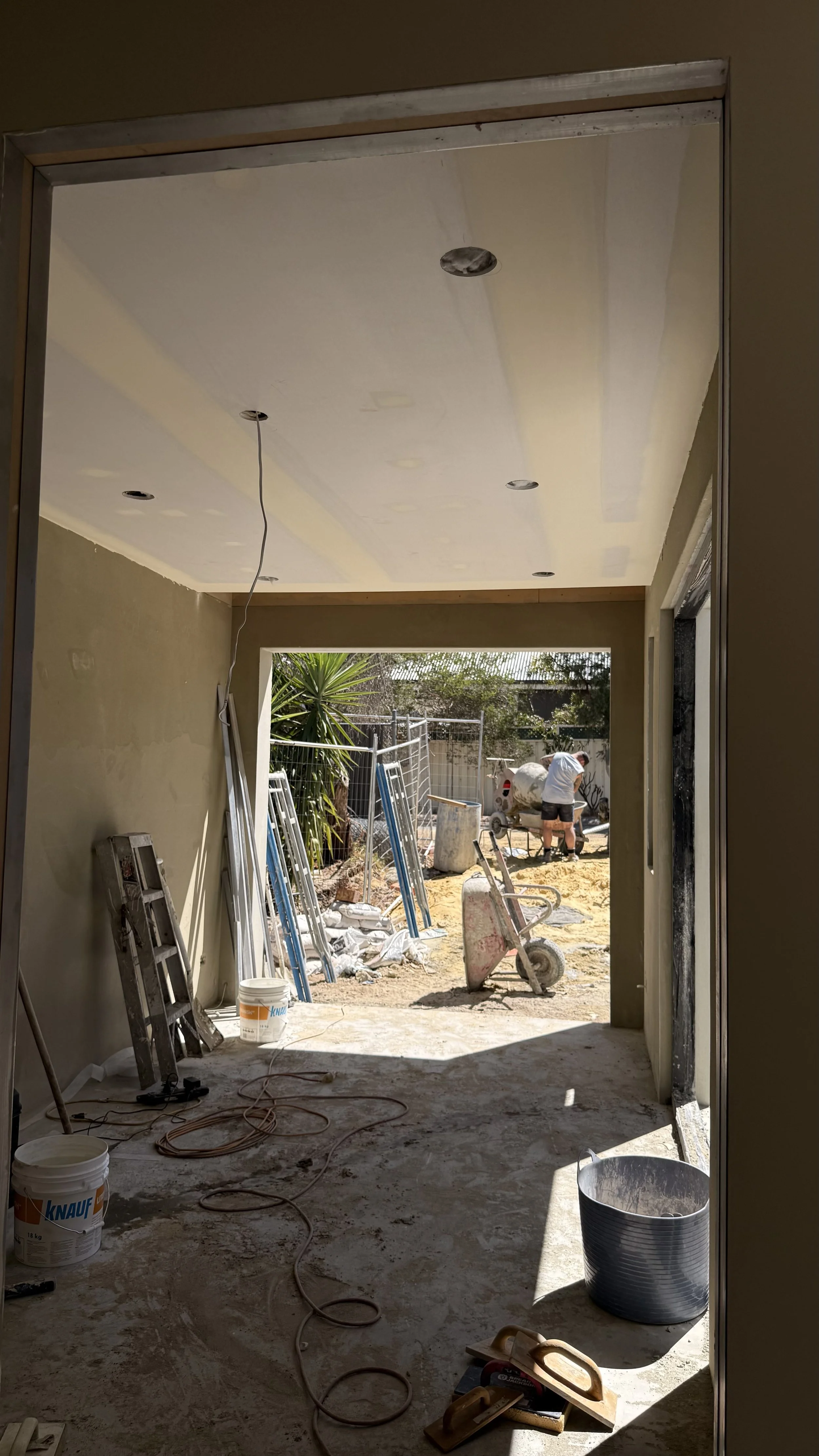 Plasterboard lining with flushed joints and downlight cutouts