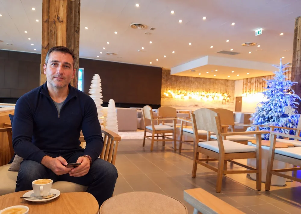 Marc Vitria, the host, with a coffee in a lounge at Club Med Grand Massif