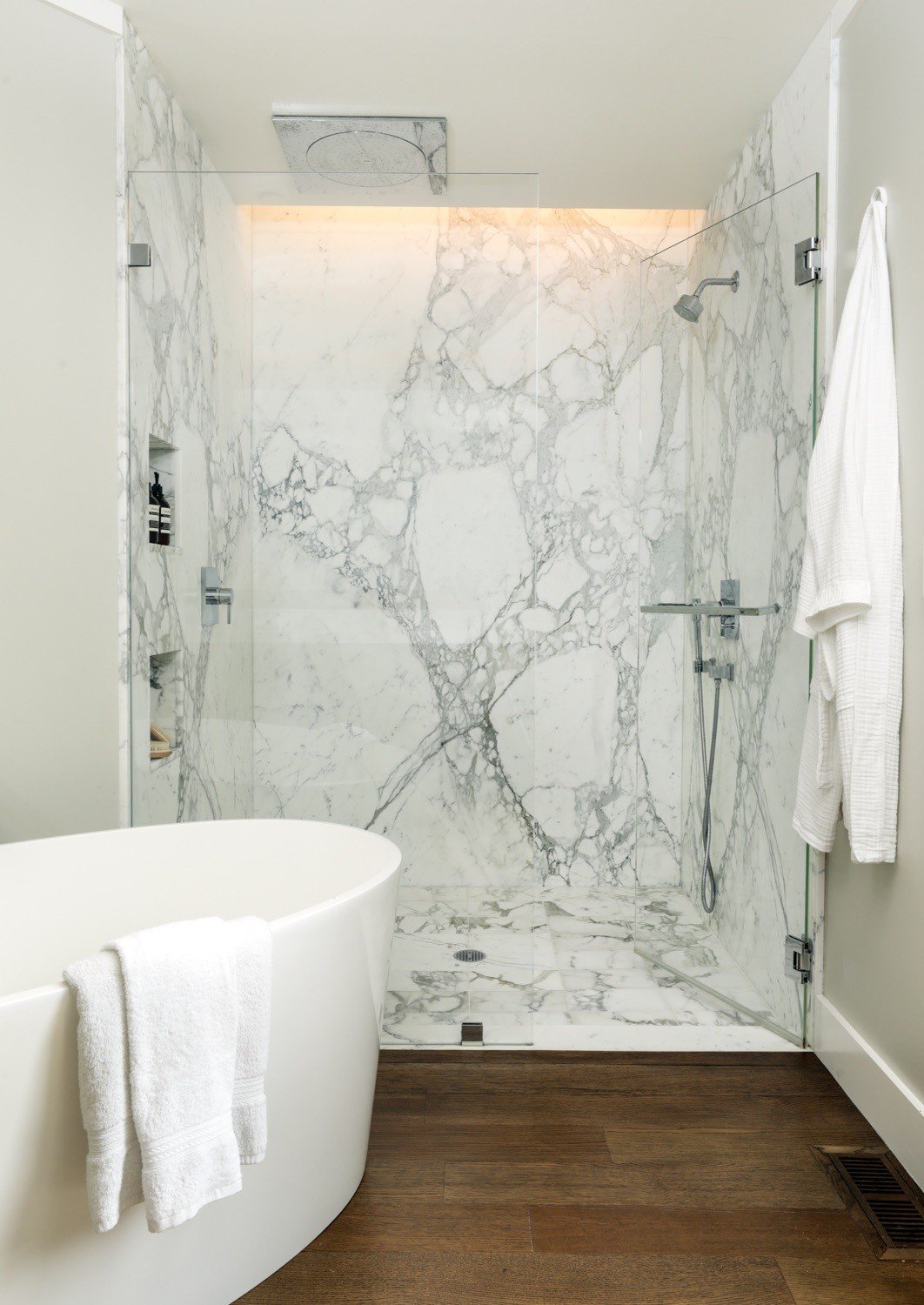 Stone surfaces and a glass shower enclosure