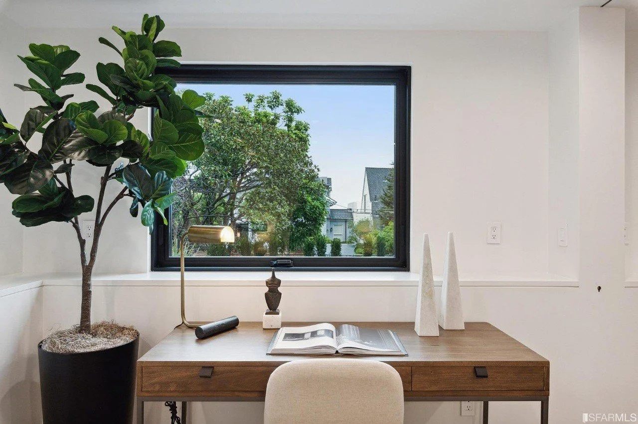 Quiet desk nook beside a large window