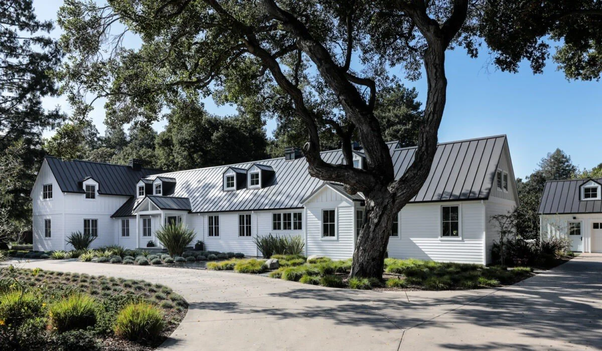 Tree-lined approach and classic white exterior