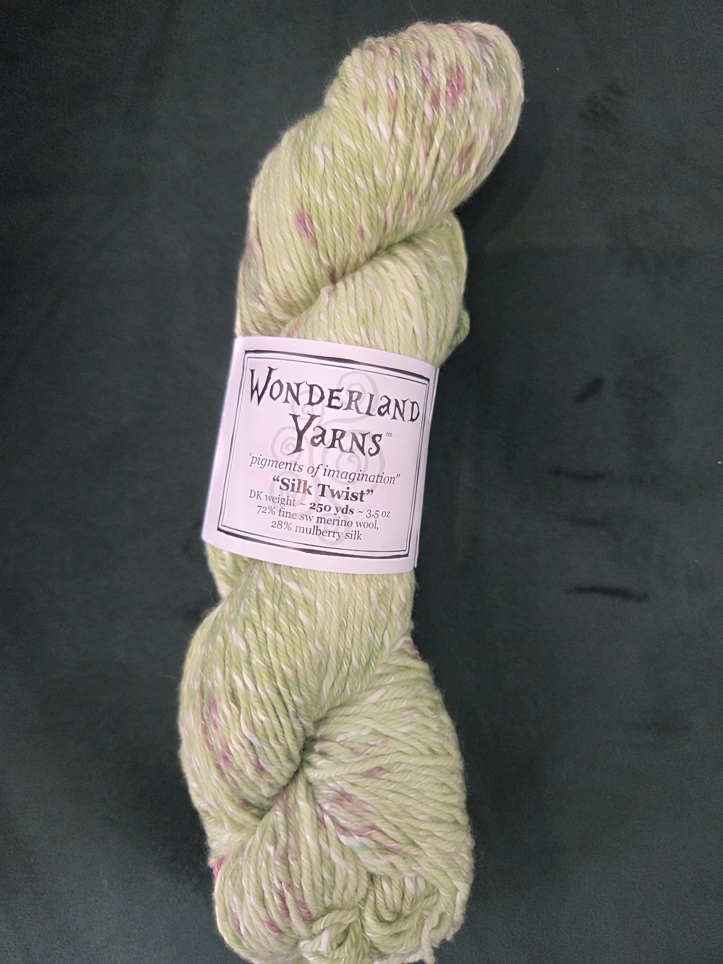 Hand-dyed DK skein with soft green speckles (Wonderland Yarns)