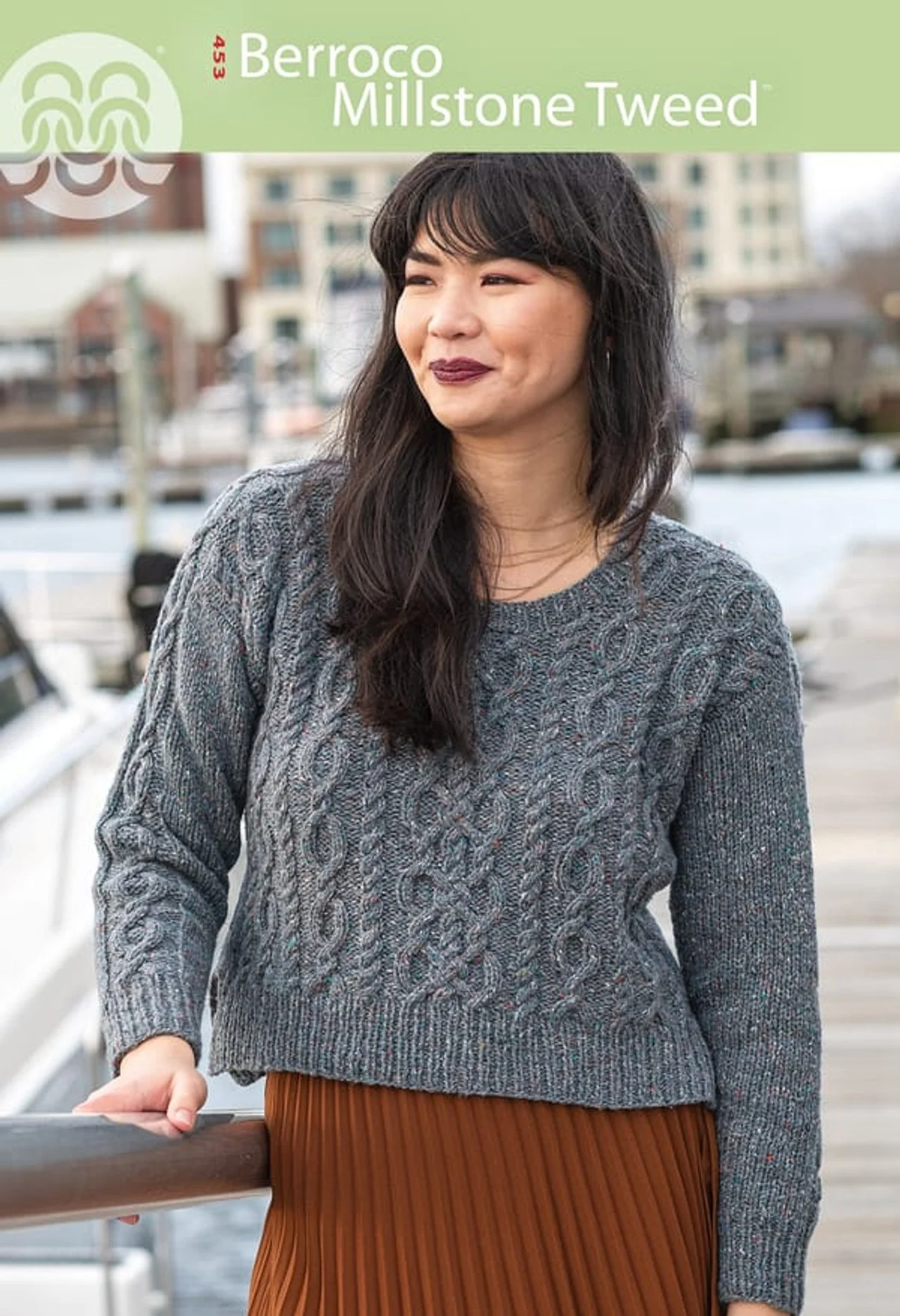 Knitting pattern booklet cover featuring a grey cable-knit sweater on a model