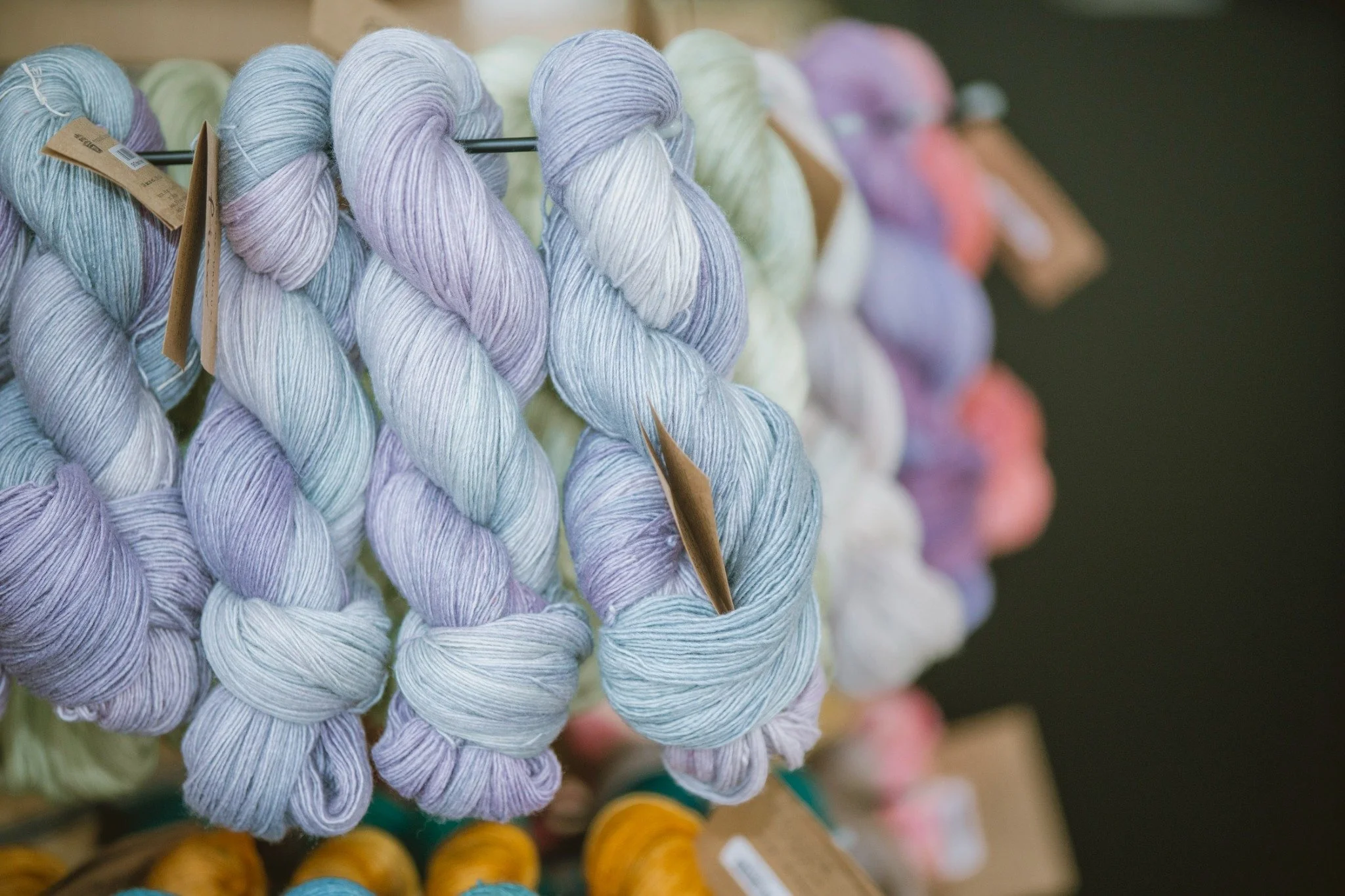 Colorful yarn skeins arranged in a gradient, ideal for choosing dye lots and planning yardage