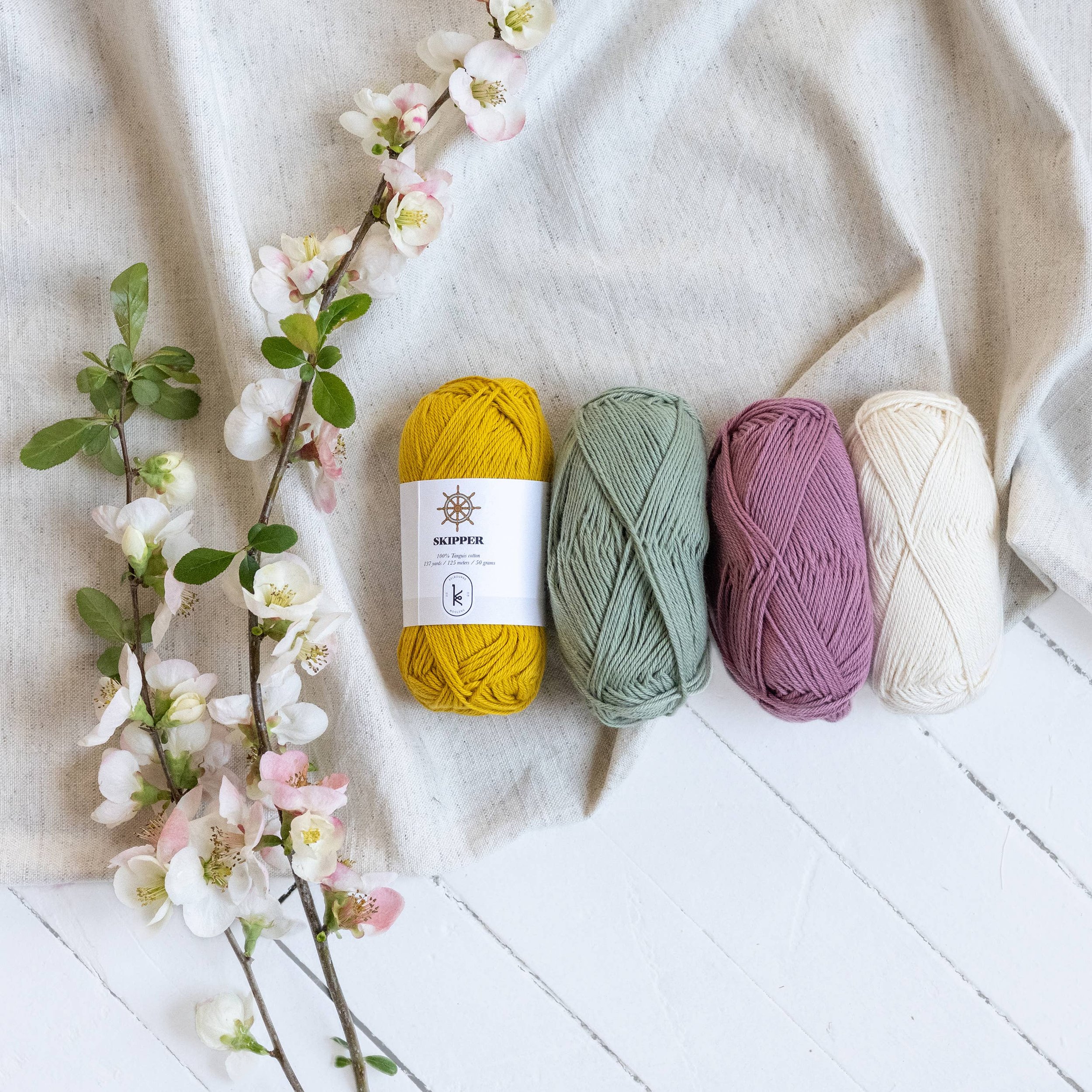 Four Kelbourne Woolens Skipper skeins in a bright Aegean palette with floral styling.