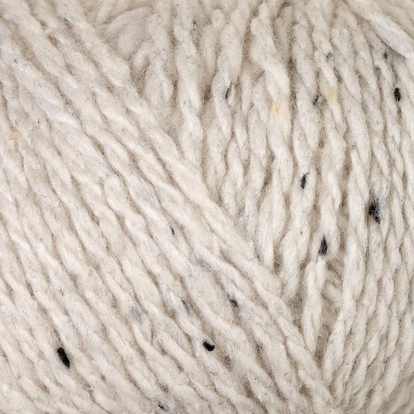 Cream and white tweed-style yarn closeup with speckles for classic knit texture