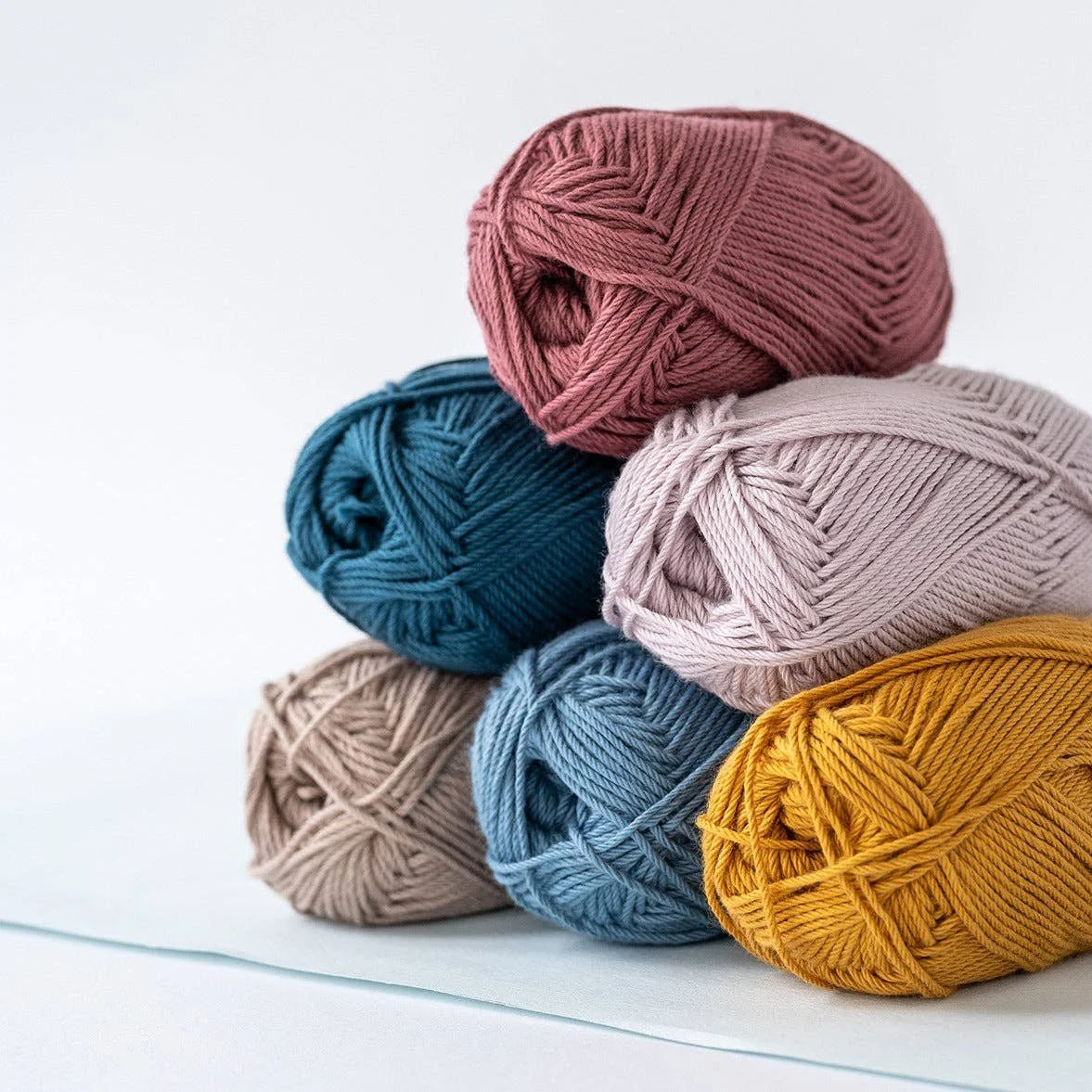 Kelbourne Woolens Skipper yarn bundled in multiple colors for stripes and colorwork planning.