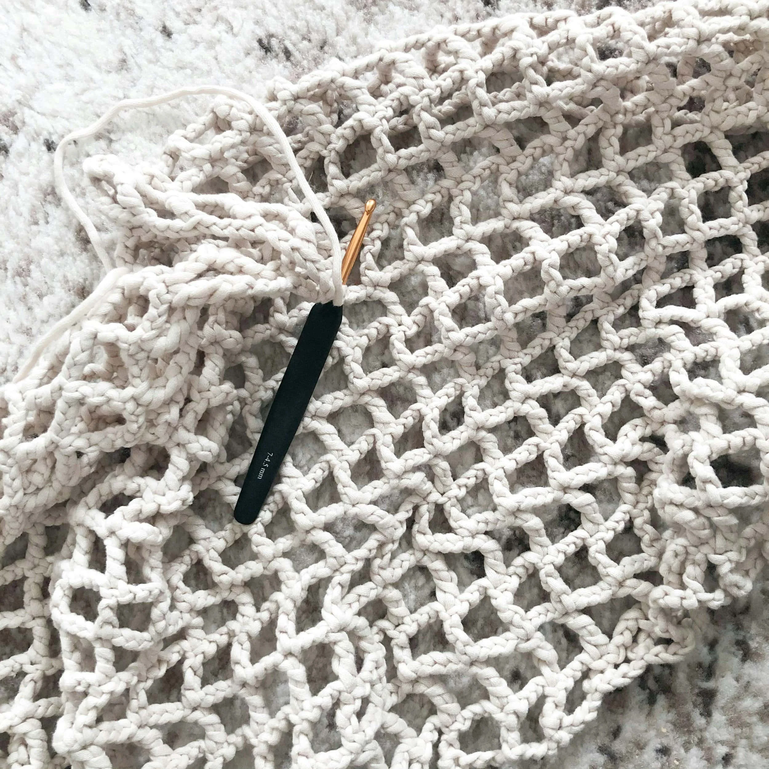 Lattice crochet swatch in neutral cotton, used as a technique sample in class.