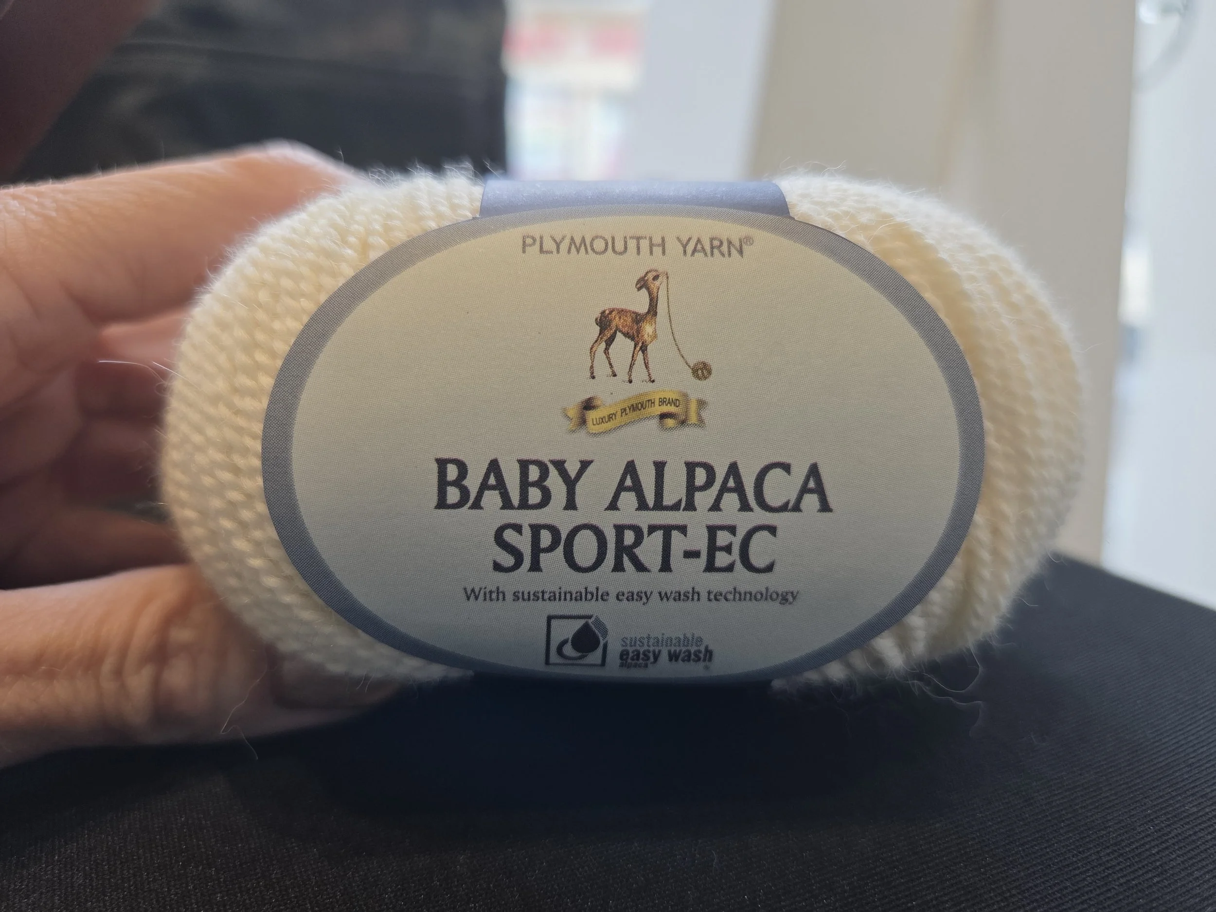 AriYARN class table with yarn and tools—ideal for learning baby blanket stitches