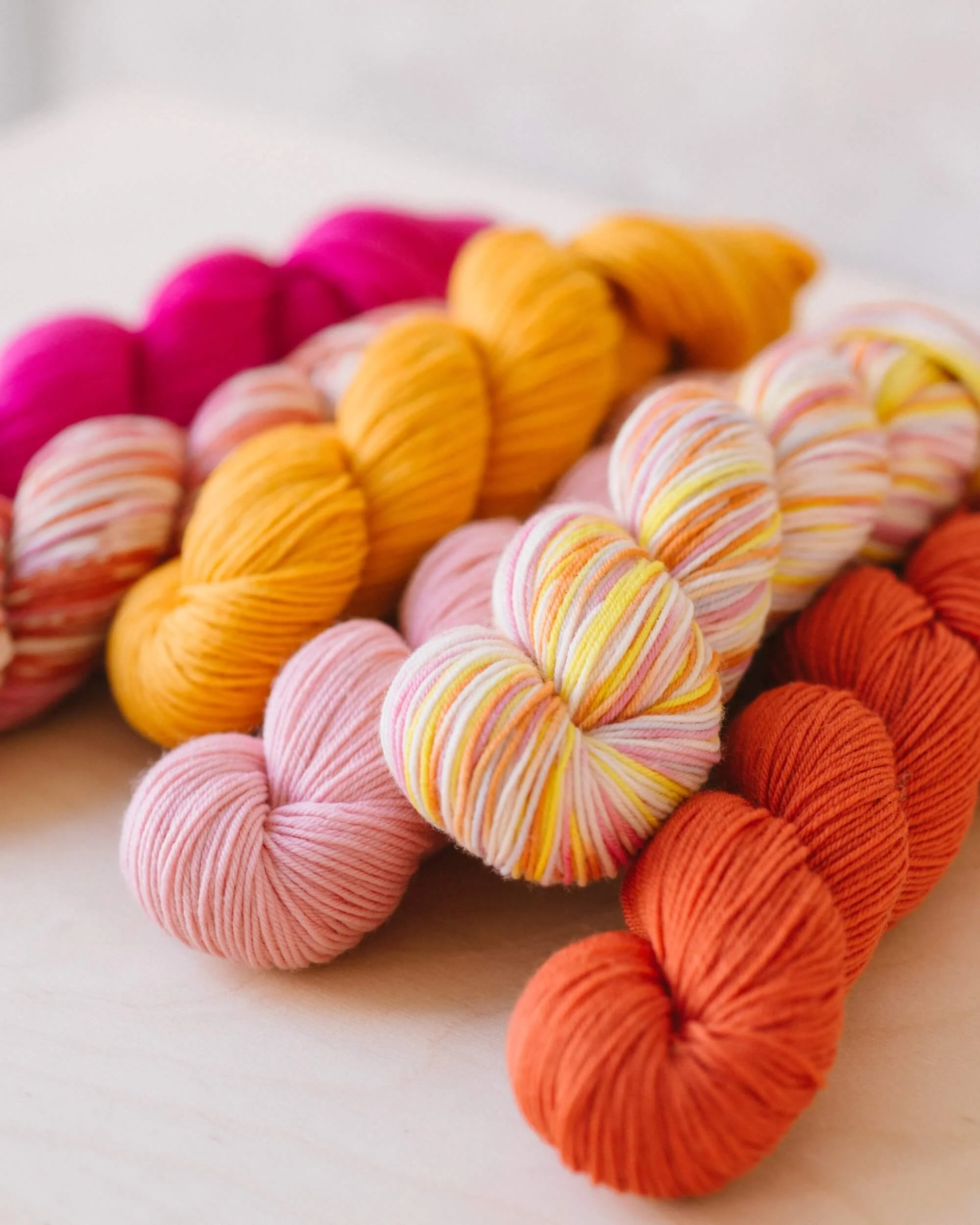 Pastel superwash merino fingering-weight skeins in mixed colors for shawls, socks, and light layers.