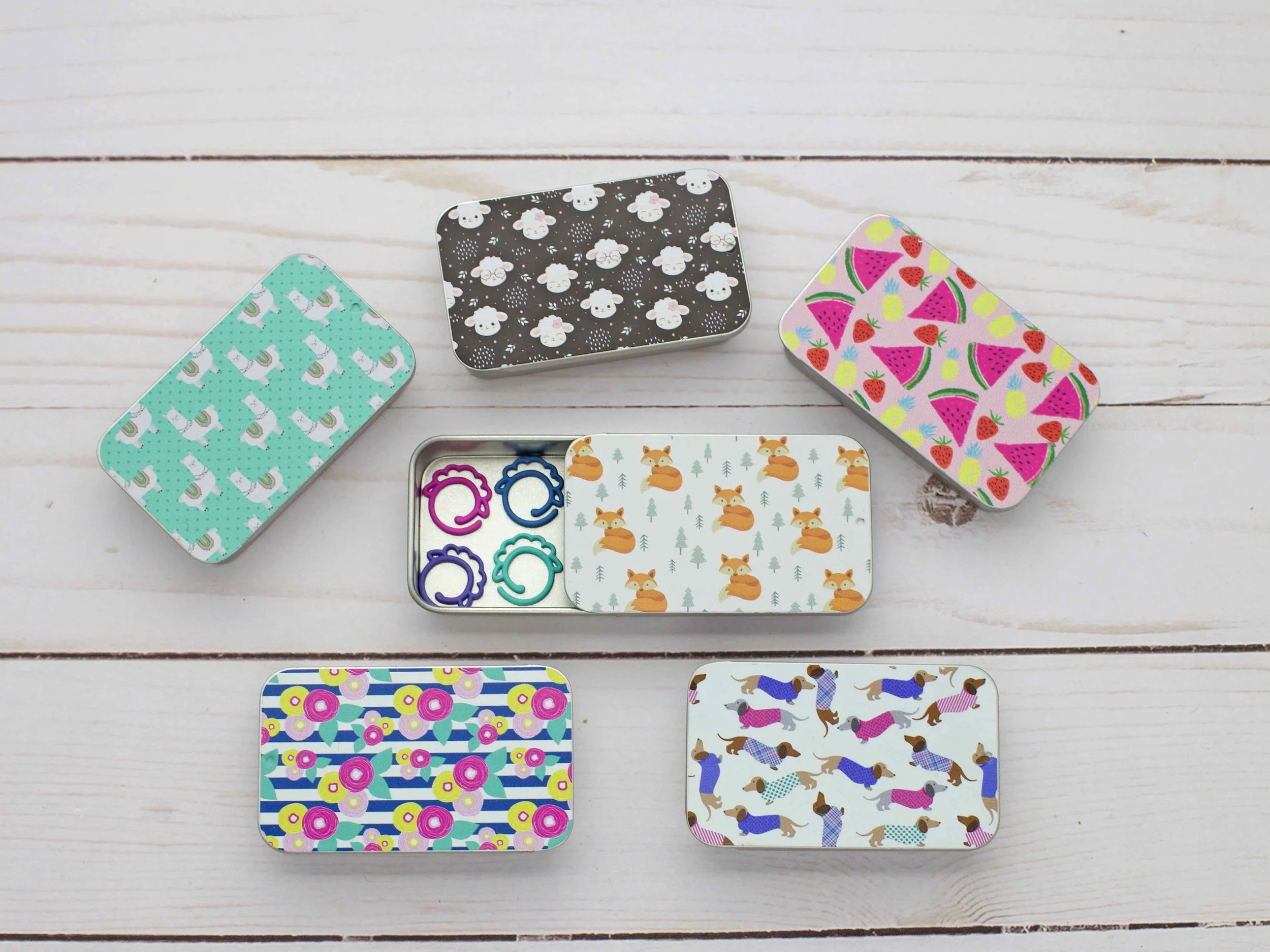Slide-top storage tins with sheep and floral prints for notions and tools