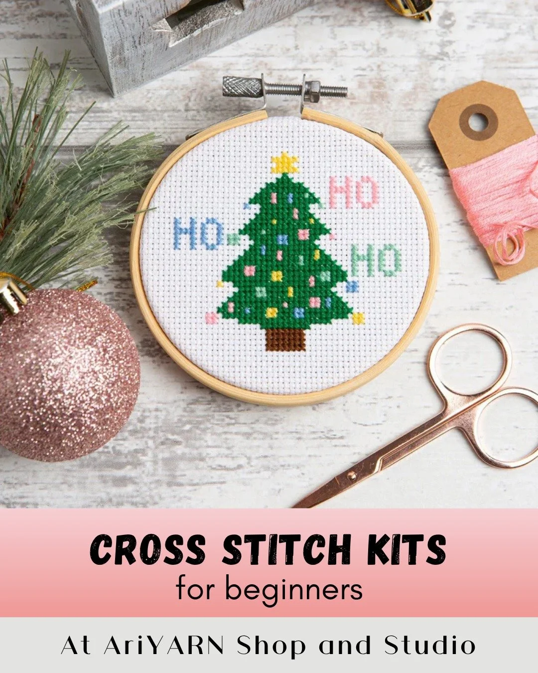 Cross-stitch hoop with holiday tree design, rose-gold scissors, and thread—beginner kit
