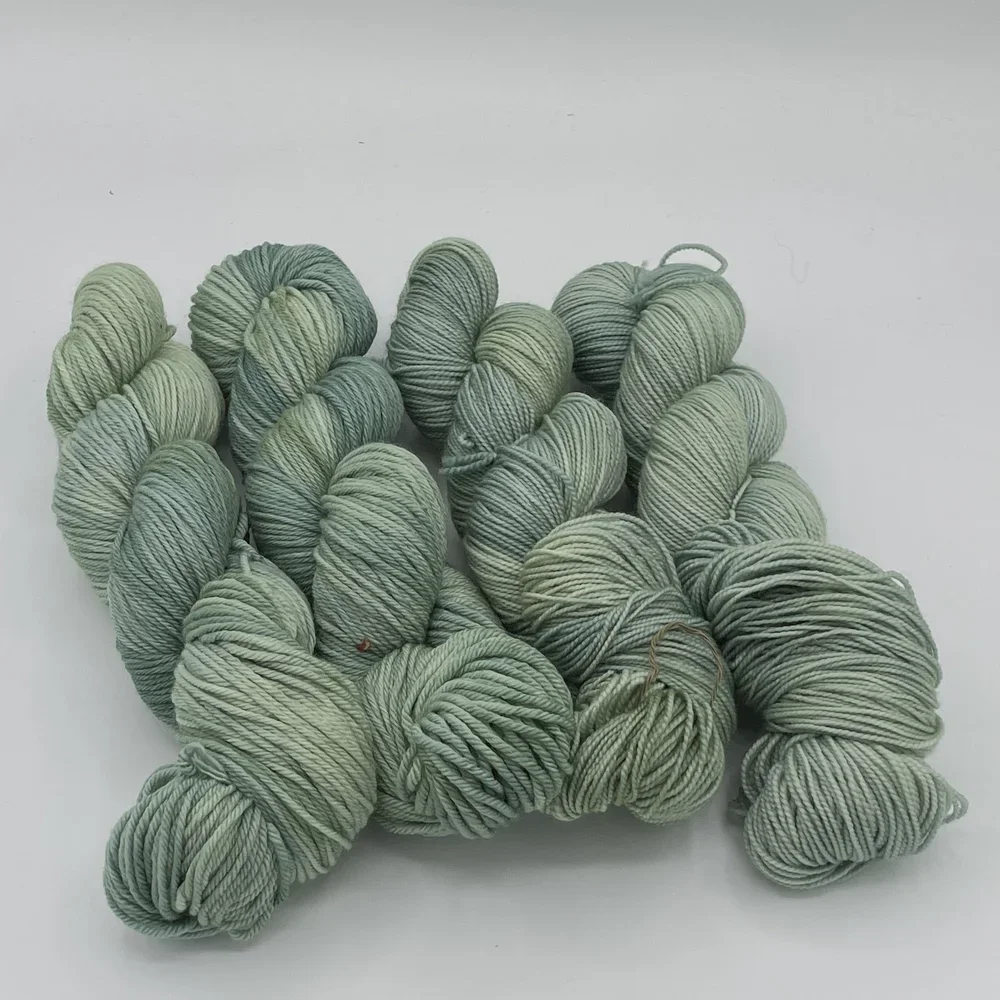 Gnome Depot hand-dyed fingering-weight yarn in layered green shades.