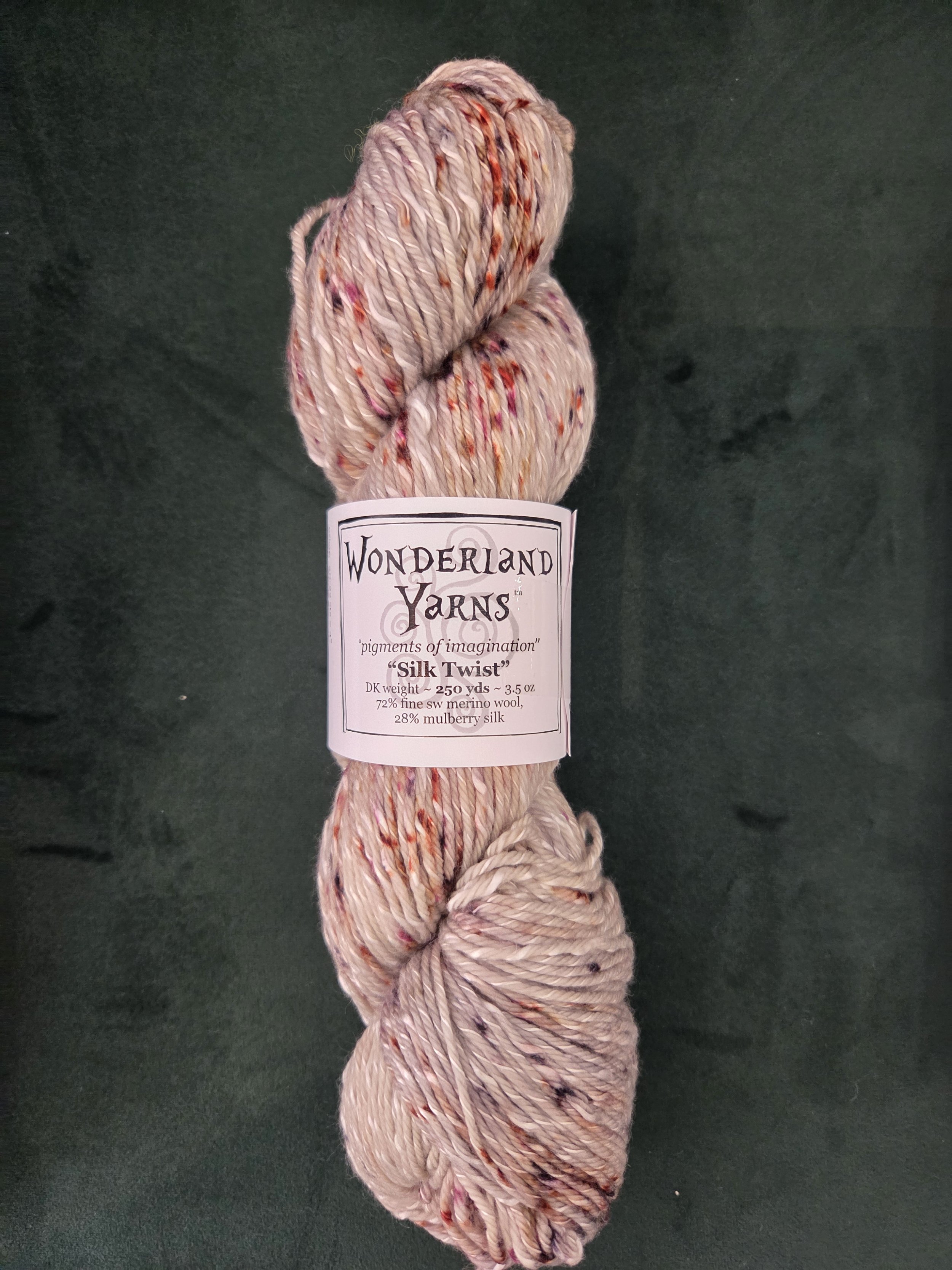 Hand-dyed DK skein with warm red-orange speckles on beige