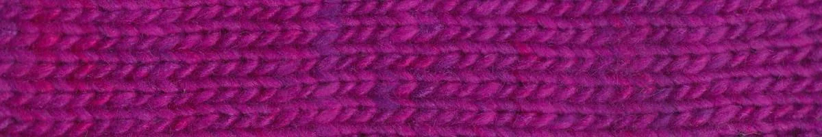 Close-up texture of Noro Sonata yarn in vibrant purple, showing stitch definition