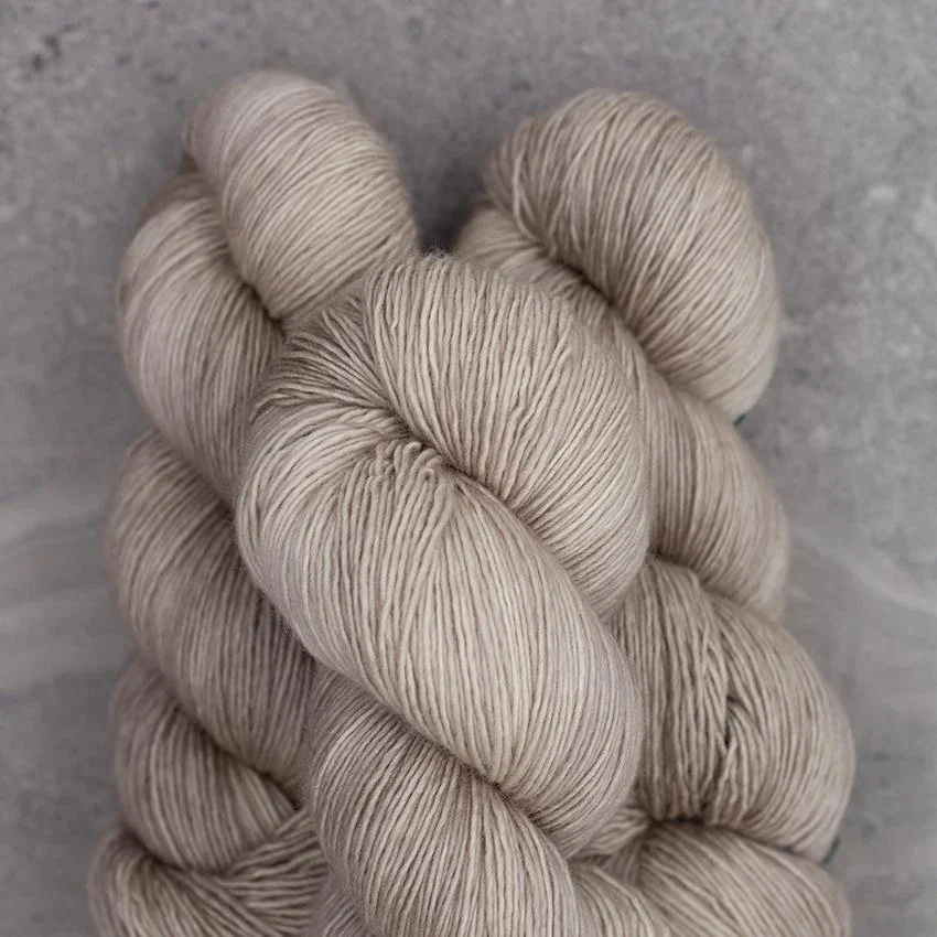 Light beige Madelinetosh sock-weight yarn skein for classic, wearable projects